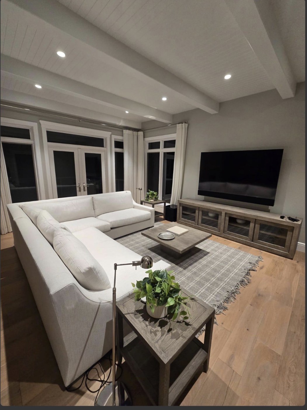 Living room with clean floors and a white sectional