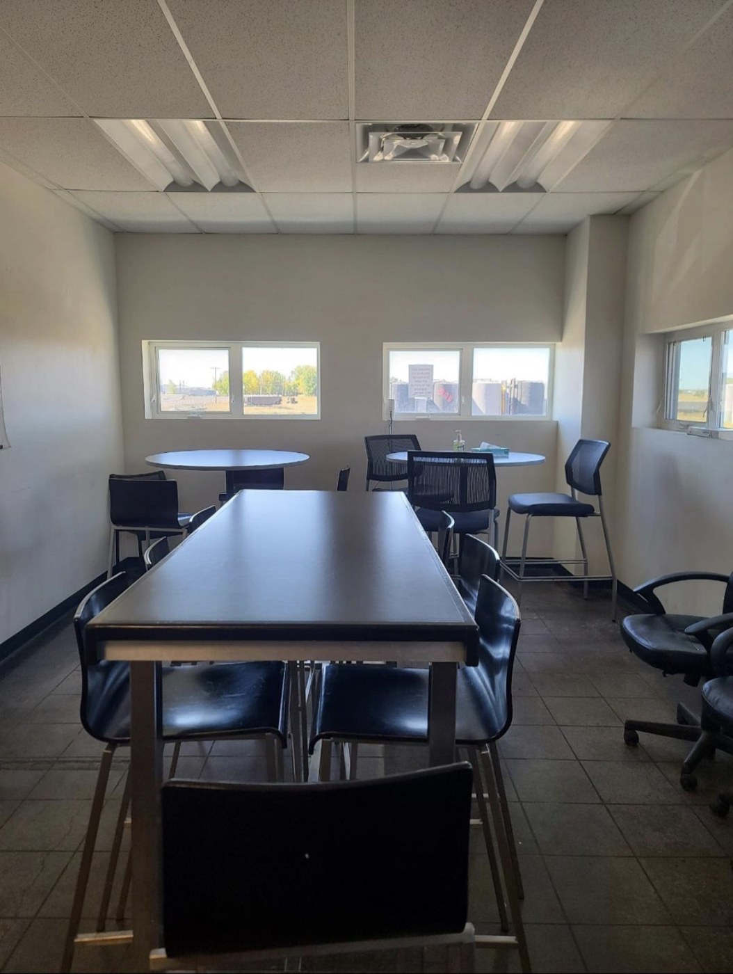 Workplace breakroom with tables and chairs